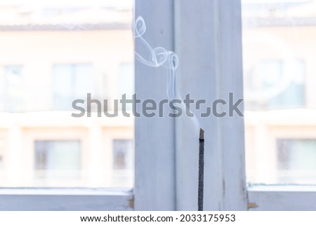 Fragrant cooal Incense sticks smoke for purify, inner peace on the windowsill  Royalty-Free Stock Photo #2033175953