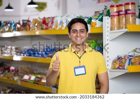 Happy young man show thumbs up at grocery store products. Royalty-Free Stock Photo #2033184362