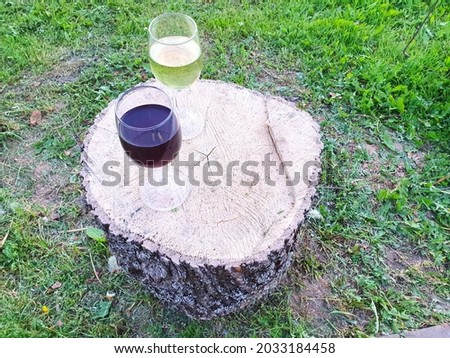 An abstract composition of boards, curtains and refreshments forming a circle with branches on a purple background.