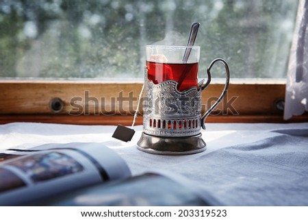hot black tea in the glass holder  Royalty-Free Stock Photo #203319523