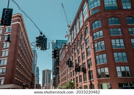 Traffic lights going all directions hanging from wire at an intersection in Boston.