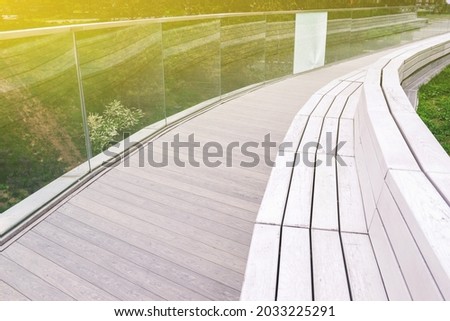 Street park bench and wooden bridge. Urban interior. A place to relax in the fresh air
