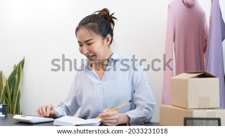 Live shopping concept a female seller counting a stock and checking a number of parcels before sending to customers by postal delivery.