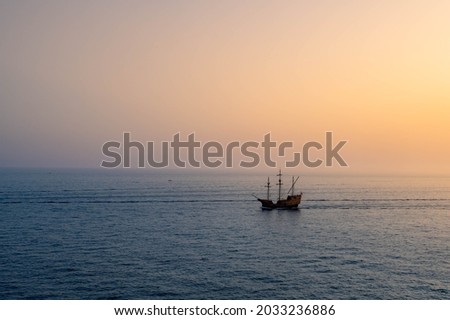 Sunset view of heritage pirate boat sailing on the horizon on the Adriatic sea