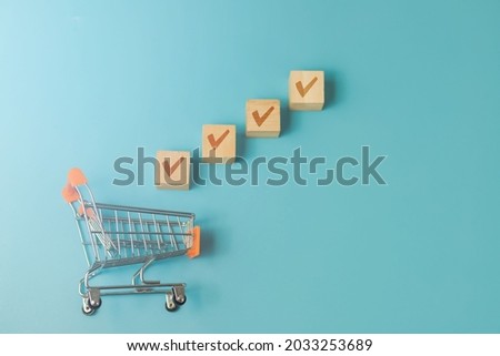 online business decision ideas Cart with correct marked wooden blocks on blue background.
