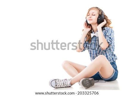 Woman with headphones listening music. Music teenager girl dancing against white background isolated