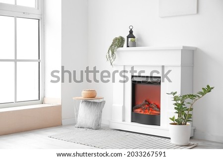 Interior of room with fireplace and houseplants