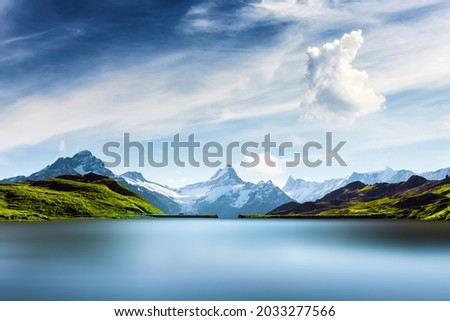 Bachalpsee lake in Swiss Alps mountains. Snowy peaks of Wetterhorn, Mittelhorn and Rosenhorn on background. Grindelwald valley, Switzerland. Landscape photography