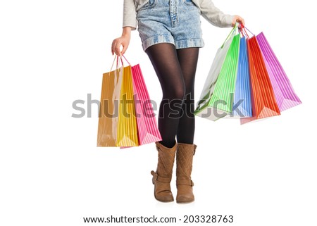 picture of woman's long legs with shopping bags isolated on white