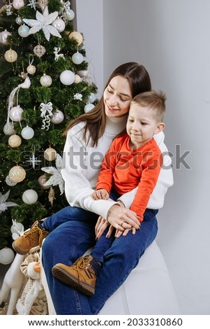 mom with son on the background of the christmas tree