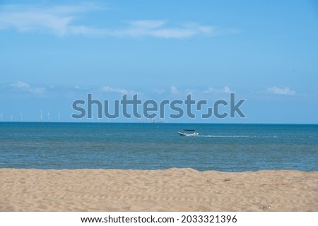 Beach, sea, blue sky, the picture is divided into three equal parts