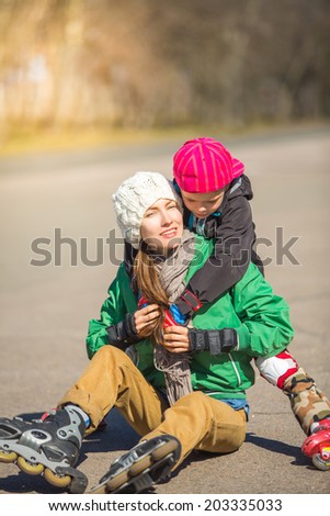 Family have fun in autumn park roller skating. Autumn outdoor active family. focus on mother