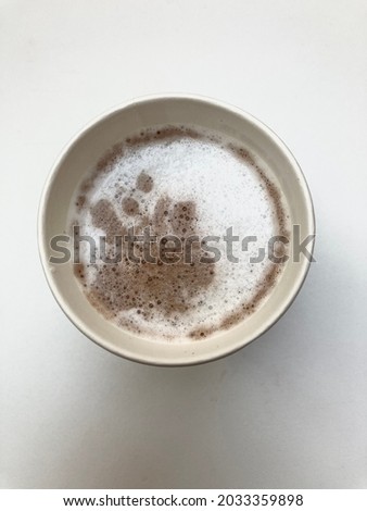 Top view of hot coffee latte on white desk