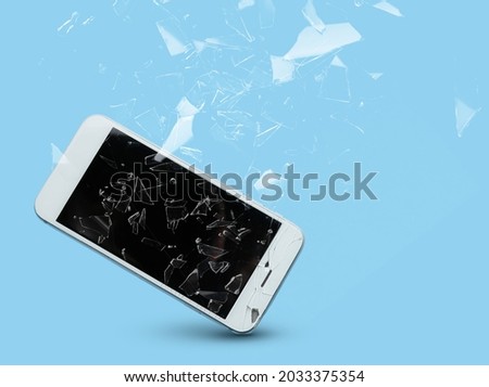 Mobile phone with cracked glass screen on color background