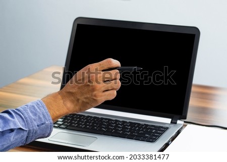 Hand pointing focus on computer in workspace office 