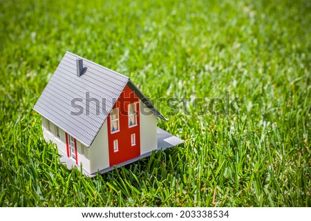 House in green grass. Real estate concept