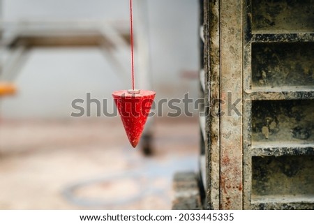 pendulum with plum for finding vertical line Royalty-Free Stock Photo #2033445335