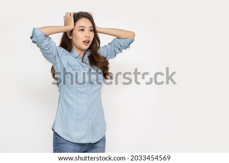 Surprised young asian woman and shocked worried isolated over white background