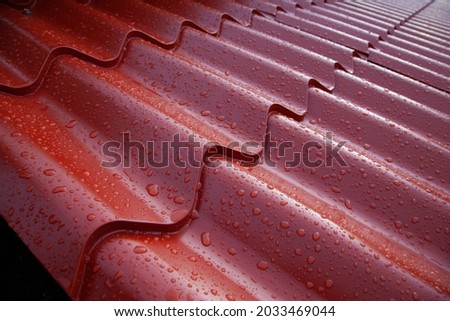 Metal spanish tile roof system. Corrugated metal sheet made of painted steel Royalty-Free Stock Photo #2033469044