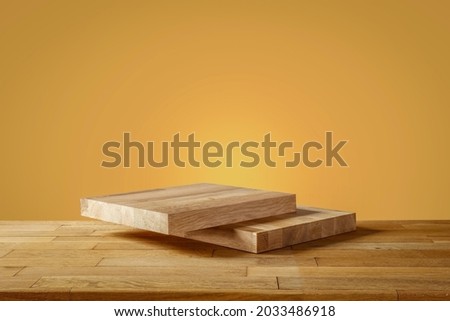 Wooden pedestal on the table, earth color background in autumn mood 