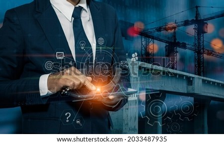 Double exposure engineering using tablet computer and digital technology web design and programming interface icons with with construction cranes no city background.