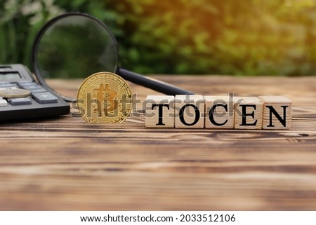 Wooden cubes with nadrtsya: "Tocen". Bitcoin coin and word: "Tocen". High quality photo