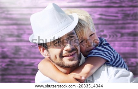Happy positive caucasian father and son hugging with happiness