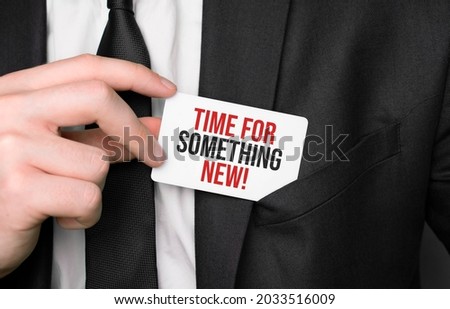 Businessman holding a card with text Time for something new