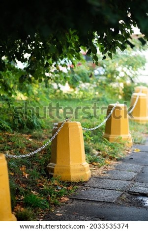 Yellow concrete road bollards installed on the sidewalk