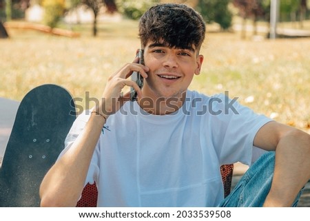 young teenager talking on the mobile phone in the street