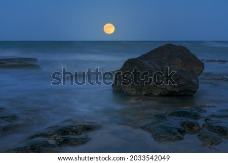 Fine art photography of a rock and the moonrise in Cervera Cape in Torrevieja, Alicante, Spain