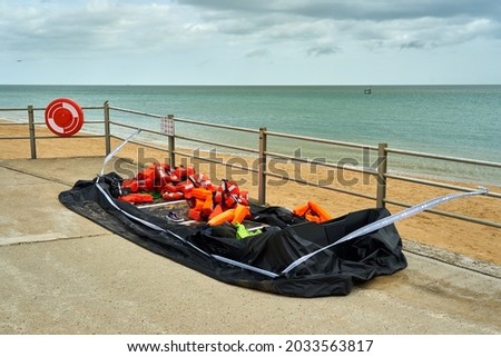 A deflated rubber dinghy used by migrants. Royalty-Free Stock Photo #2033563817