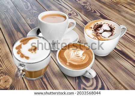 collection of a hot coffee cup, cappuccino, espresso, black coffee and hot tea on the desk Royalty-Free Stock Photo #2033568044