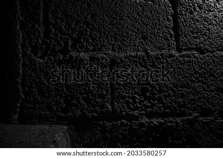 Stone wall dark background with light. Grunge style wall for background