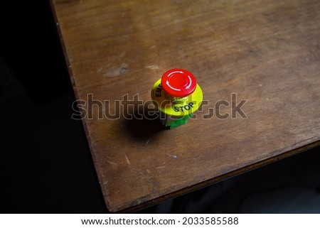 Emergency stop button, Disaster protection. Industrial concept. Red button on table in dark low key background. Selective focus