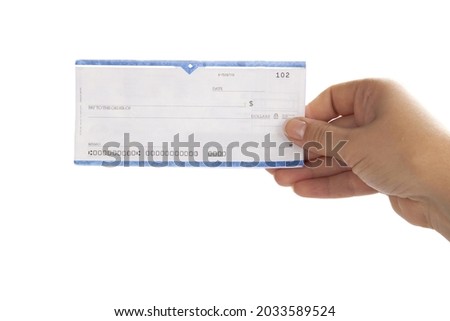 Woman's Hand Holding a Check Royalty-Free Stock Photo #2033589524