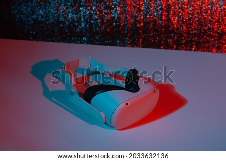 Virtual reality helmet on white background in neon light. VR, future, gadgets, technology concept.