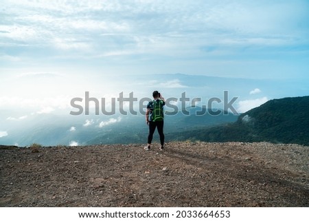 mountain climber taking a picture from the top of a Santa Ana volcano, el salvador volcano
