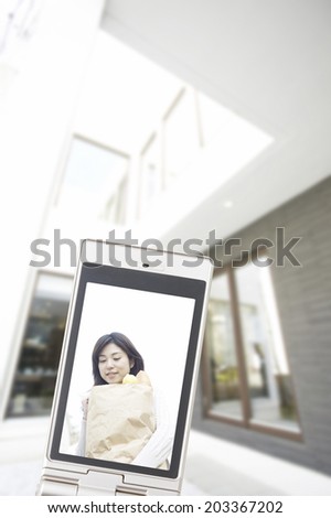 Woman With Shopping Bag Reflected In Mobile Screen