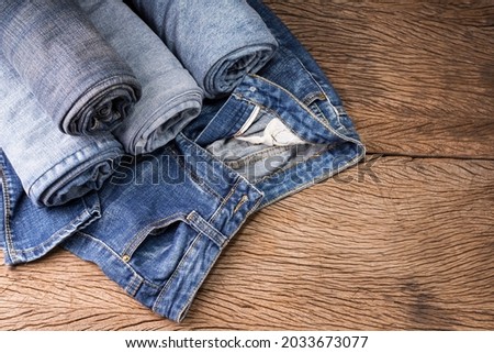 jeans laid on a wooden floor modern fashion jeans top view with copy space