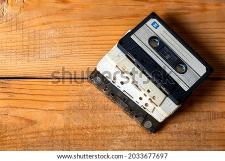 Old Audio Cassettes on a Wooden Planks Background closeup