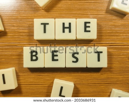 Business concept.Selective focus.Scrabble letters with text THE BEST on wooden background.