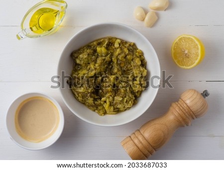 Middle Eastern cuisine-babaganush (eggplant caviar) from baked eggplant, garlic, tahini, lemon, olive oil, mint. Step-by-step recipe. Royalty-Free Stock Photo #2033687033