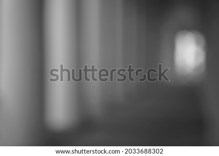 Blur abstract background from walkway in twilight.  BLURRED BUSINESS BACKGROUND, GLASSY WALL, HALLWAY, COMMERCIAL SPACE. 