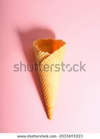 Empty ice cream waffle cup, cone cone on pink background.