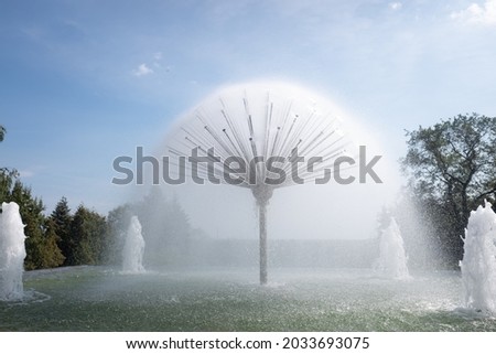 City fountain in summer against the sky, natural park.