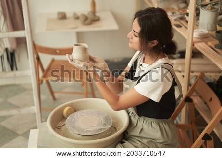 Artisan making earthenware in pottery studio