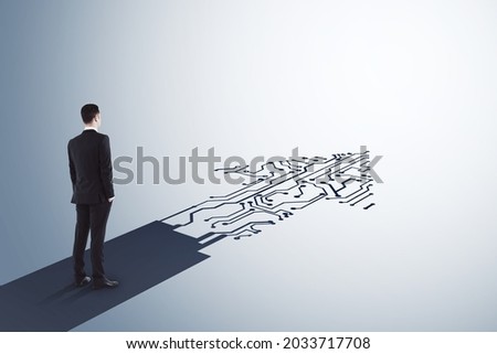 Businessman standing on abstract circuit arrow sketch on white background with mock up place. Success and digital transformation concept Royalty-Free Stock Photo #2033717708