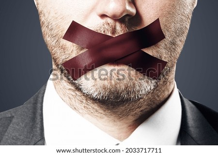 Close up of taped caucasian businessman mouth. Silence and speech censorship concept Royalty-Free Stock Photo #2033717711