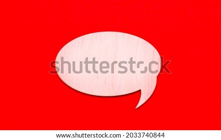 On a bright red background, a light wooden curly card with a place to insert text